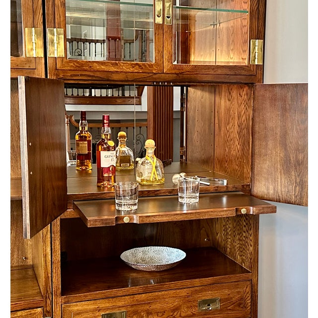 A beautifully crafted vintage Henredon campaign-style cabinet, thoughtfully designed as a full-service home bar and...