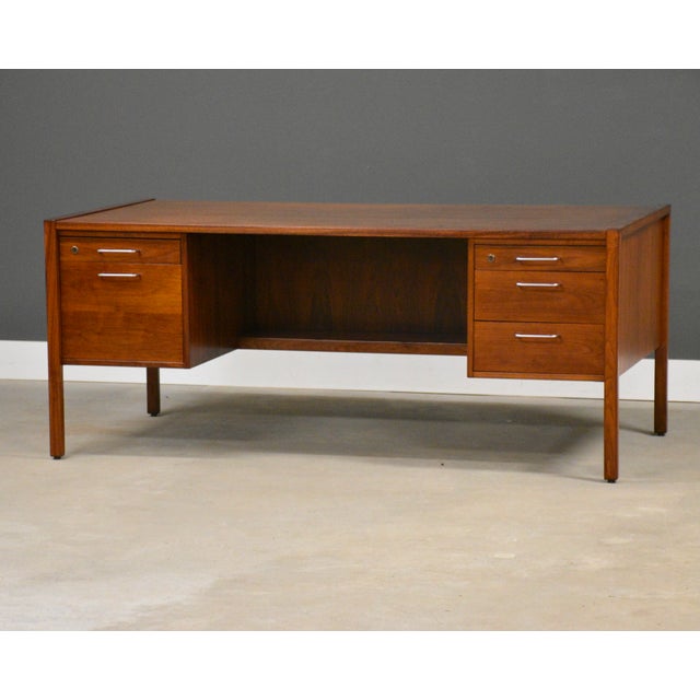 A mid century modern walnut double bank desk with chrome pulls and a finished back designed by Jens Risom. Made in USA....
