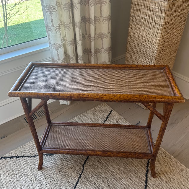 Lovely vintage cane and bamboo 2 tiered console table with tortoiseshell finish. A classic piece with endless versatility.