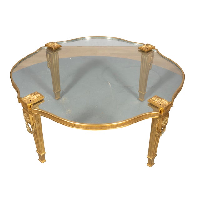 In the French taste with shaped circular top with inset thick glass with bronze reeded border. The square tapered fluted...