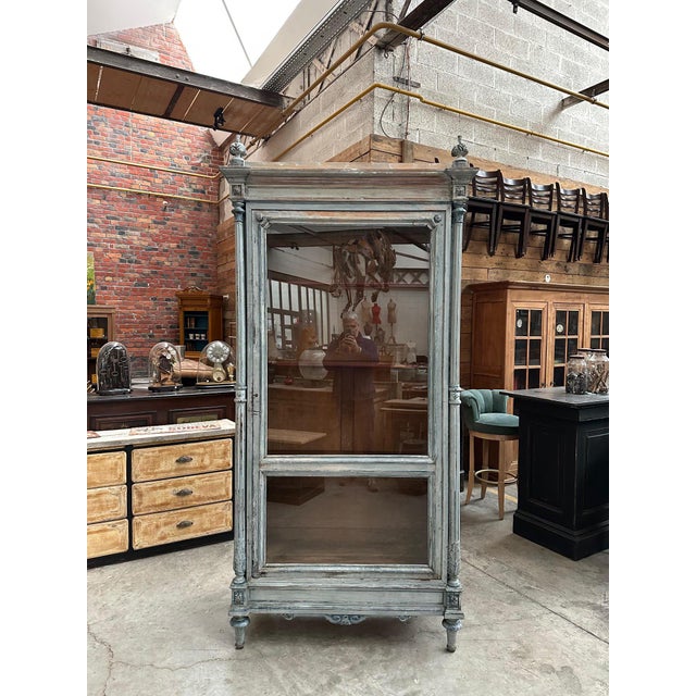 This antique Louis XVI-style display cabinet has been fully restored. It features a large glass door opening onto three...