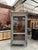 This antique Louis XVI-style display cabinet has been fully restored. It features a large glass door opening onto three...