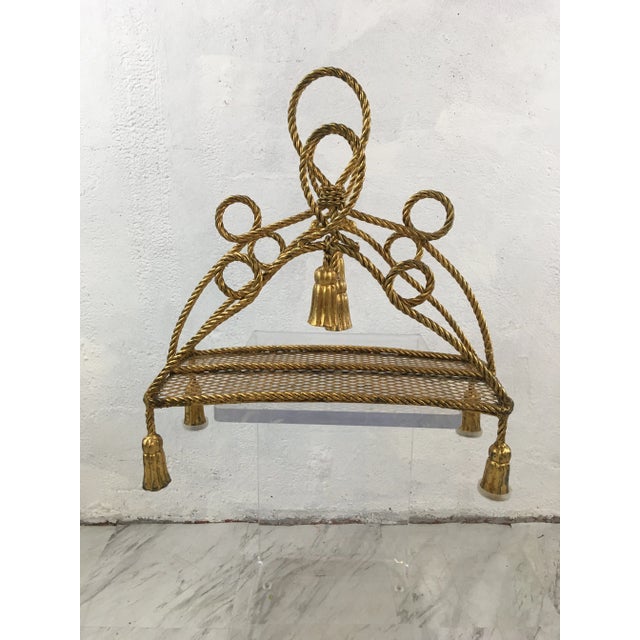 Fabulous, ornate Hollywood Regency magazine rack in gold. Tassels and curves! Perfect!
