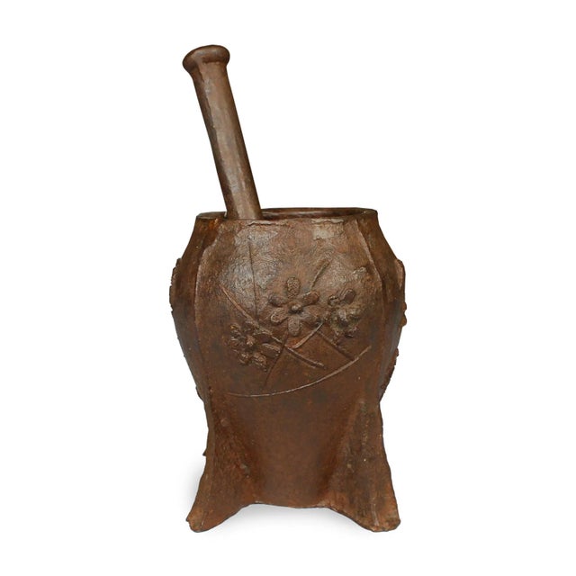 This vintage cast iron mortar from China's Shanxi province is patterned in low relief with a simple floral design....