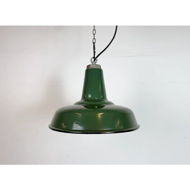 Industrial green enamel factory pendant light made in United States during the 1960s. White enamel inside the shade. Iron...