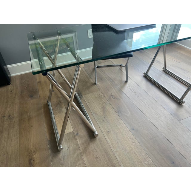 Glass and chrome trestle desk purchased from Cantoni in Dallas. The clear glass top and sawhorse-style supports create an...