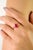 This elegant engagement ring showcases a captivating pear-cut natural ruby weighing 1.21 carats, set in lustrous 14K...