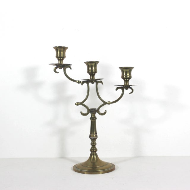 Width: 8.5 inches Height: 12 inches Depth: 4 inches Vintage brass candelabra with three staggered height arms. In good...