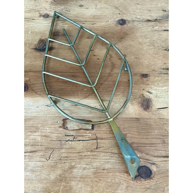 This exquisite pair of vintage Italian brass trivets features a striking stylized leaf design, capturing the playful yet...