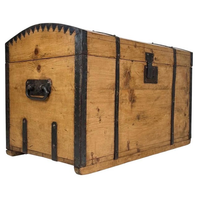A handsome 19th-century English dome-top storage chest, substantially constructed from pine and distinguished by its...