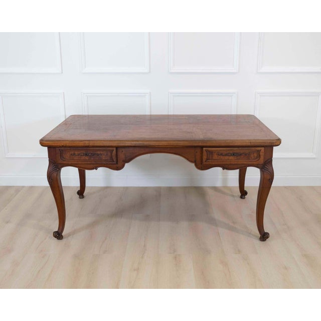 This elegant Louis XV style flat desk, crafted in the 20th century from solid walnut and elm, features a beautiful curved...