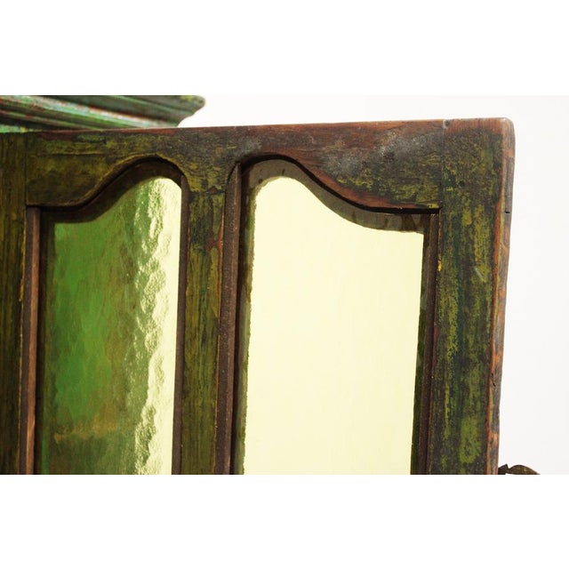 Elegant ethnic style piece of furniture with central showcase opening in green colored glass and structure entirely in...