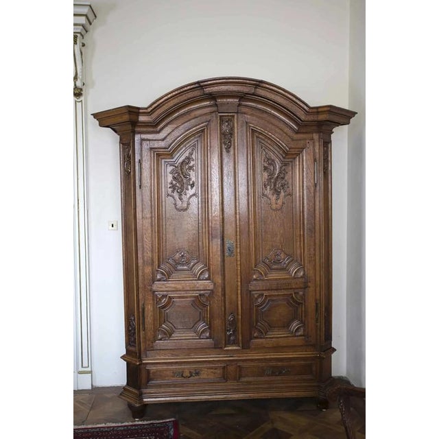 Wardrobe made of solid oak carved with a floral motif. The upper cornice is typically Baroque with rich profiling. The...