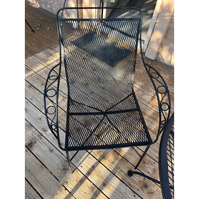 classic 3-piece Mid-Century Modern bistro set. Crafted from heavy-duty, commercial-grade black wrought iron, this durable...