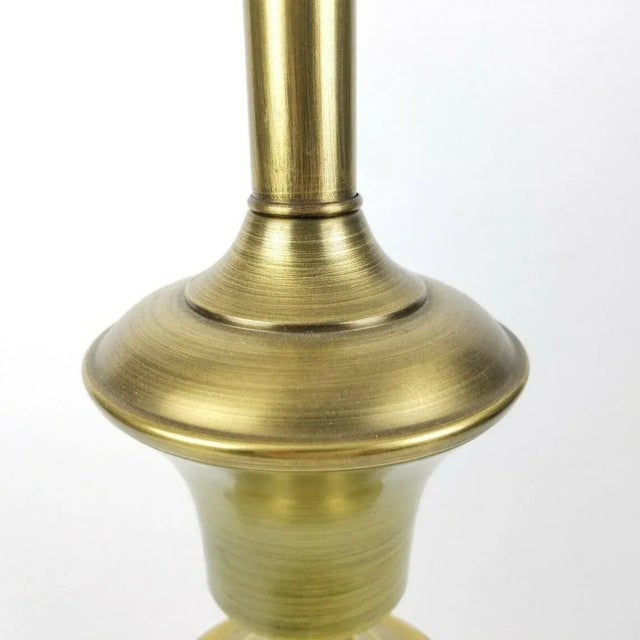 A tall mid century modern, olive green accent lamp. Made of metal. The metal accents are brass toned. Wiring is original...