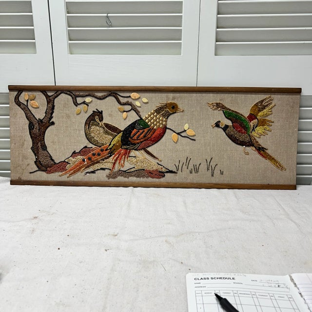 Lovely mid century pebble art of pheasants and duck in a tree setting. Mounted on a linen look backing with wood rail on...
