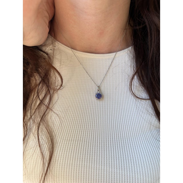 Cue the compliments. This adorable pendant features a glowing 2.16ct round tanzanite with a halo of sparkly earth-mined...