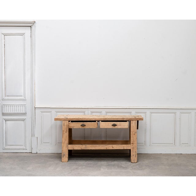 Antique workbench made of solid fir, dating from the 1940s, completely stripped to reveal the wood's light, natural color....
