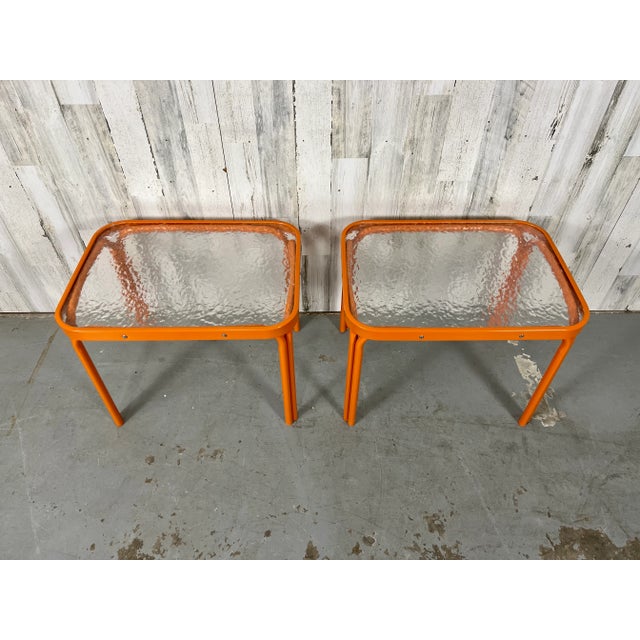 Pair of Tamiami style model side tables from Brown Jordan with fresh Citrus orange powder-coating. The original pebble...