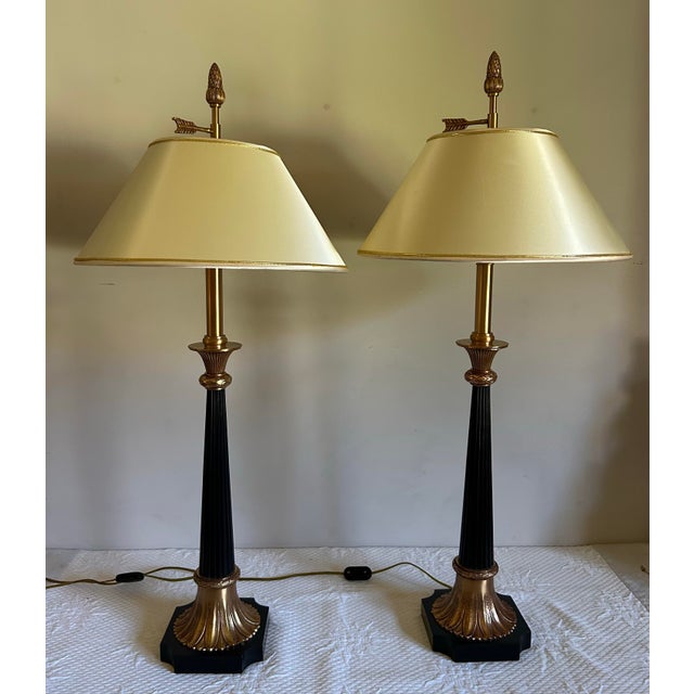 Beautiful, vintage pair of Maitland Smith gold and black table lamps. Features ebonized columns with gold ornate details....