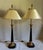 Beautiful, vintage pair of Maitland Smith gold and black table lamps. Features ebonized columns with gold ornate details....