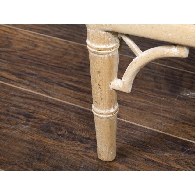A rustic vintage English Chinese Chippendale style lounge chair from the mid 20th century, with bleached faux bamboo...
