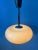 UFO-like acrylic glass space age pendant lamp in beige coffee colour. The acrylic glass shade produces a warm glow. The...