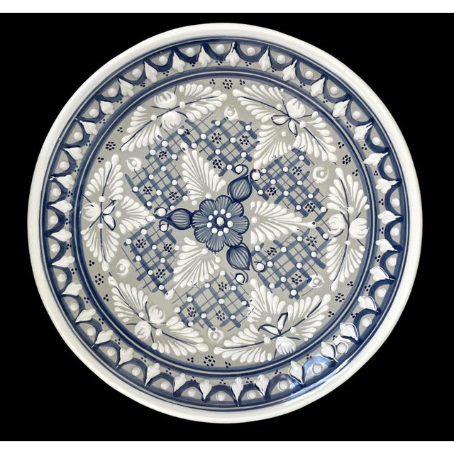 These 4 Talavera pottery plates originate from Juarez, Mexico, showcasing a beautiful blue and white design that is...