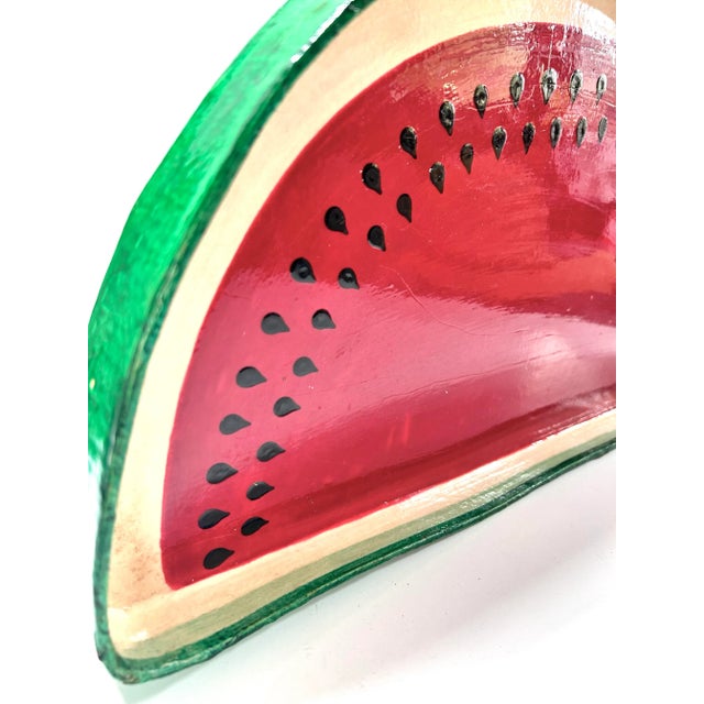 A playful vintage folk art watermelon tray crafted from lacquered paper mâché and hand-painted in vibrant red, green, and...