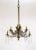 An 1880s, formerly candle-lit chandelier, newly electrified. A fully brass structure with a rich patina and ornate brass...