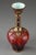 Bulb-bottomed vase with long neck decorated with multicolored enamel and gold. It is embellished with arabesques, flowers...