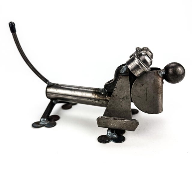 Quirky metal dog statue created with nuts and bolts which sits stable and heavy. Rustic and industrial style with a fun...