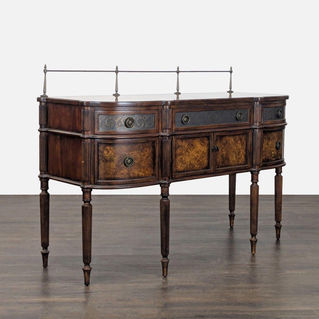 This elegant sideboard features a wood finish with burl veneer, decorative metal inlays, ornate drawer fronts and top, and...
