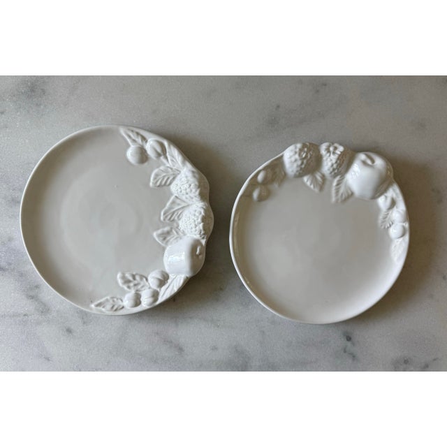 Pair of vintage white glaze ceramic plates with fruit motif relief on the edges. Made in Italy. Perfect to serve small...
