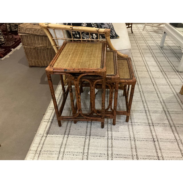 Set of three burnt bamboo nesting tables.