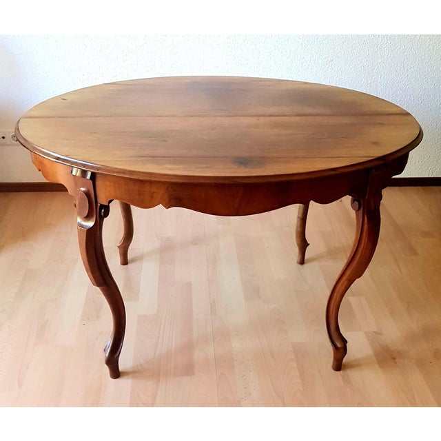 The table is made of solid walnut wood. The dimensions are 120 cm long 86 cm deep 75 cm high