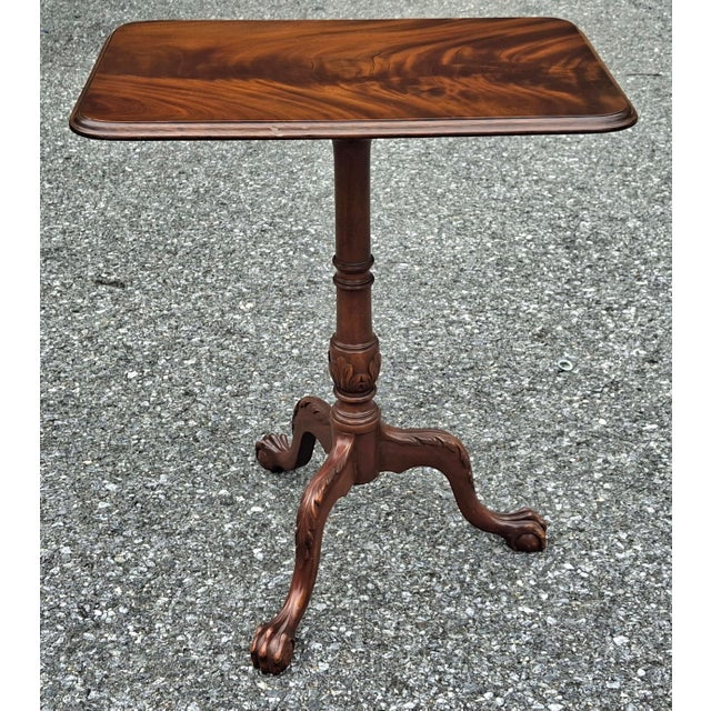 A George III Style Crotch Mahogany Pedestal Tilt Top Side Table Measure 28.5" in height and 24" in width and 16" in depth.