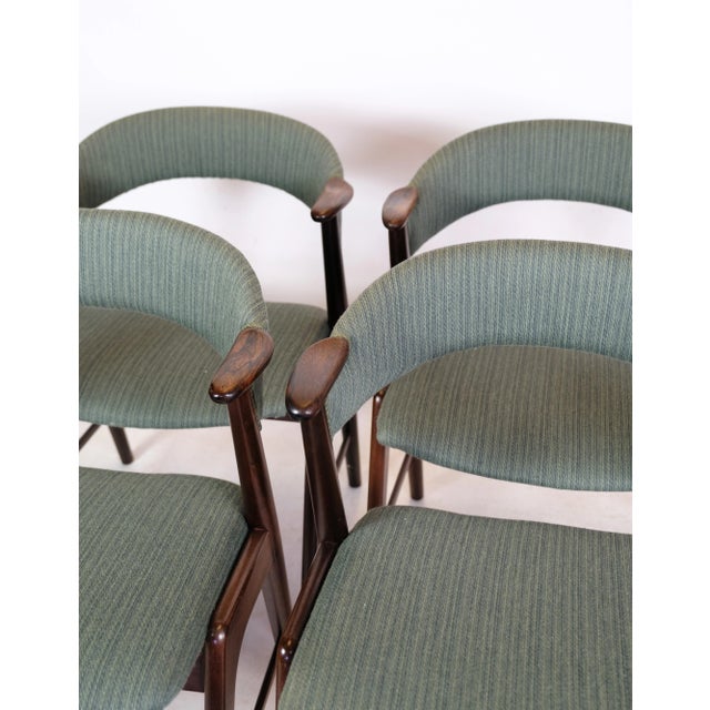 Set of 4 armchairs of danish design in rosewood manufactured by korup stolefabrik in blue fabric from around the 1960s....