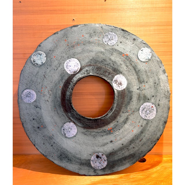 A beautiful and striking circular ceramic wall sculpture by Danish ceramicist, Ann Floche. The multi color glaze in pale...