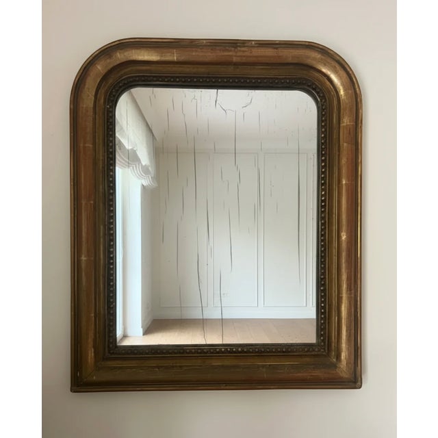 A warm, intimate mirror sourced from a Roman home...the kind of piece that anchors a bedroom wall or catches light in a...