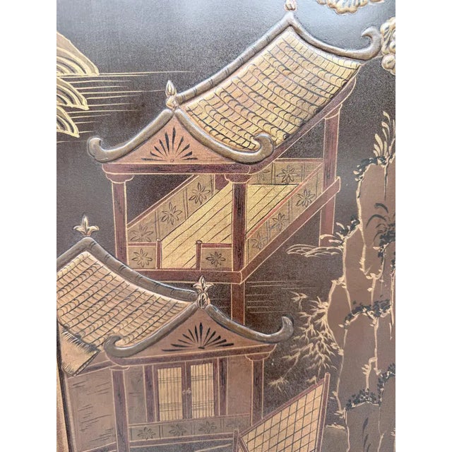 Spectacular six panel Chinese coromandel folding screen with hand-painted relief gilt decoration. This large Chinoiserie...