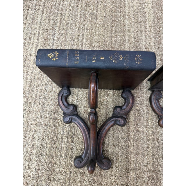 These are beautiful wall shelves from the late 19th century. They are unique crafted of wood with a leather front binding...