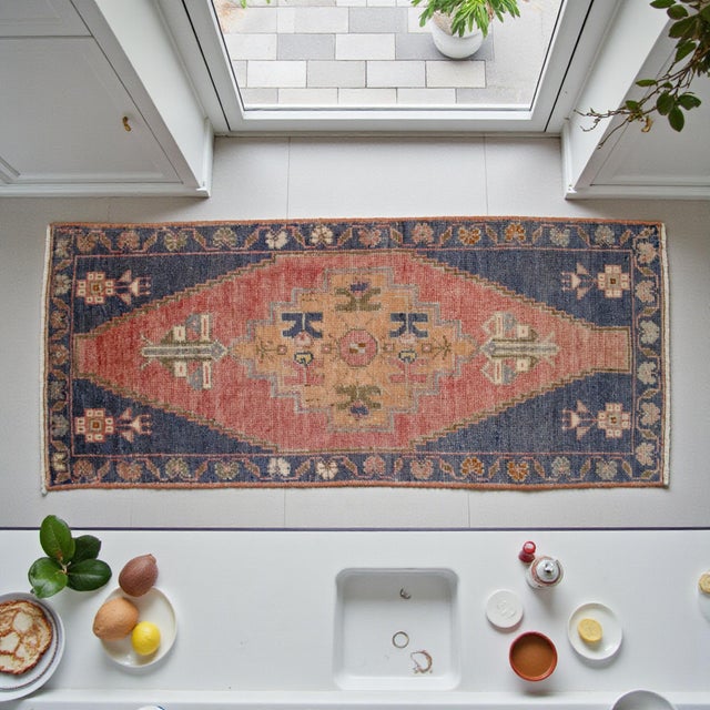 Vintage Turkish small hand-knotted rug from Taspinar, circa 1970, featuring warm terracotta and navy tones and authentic...