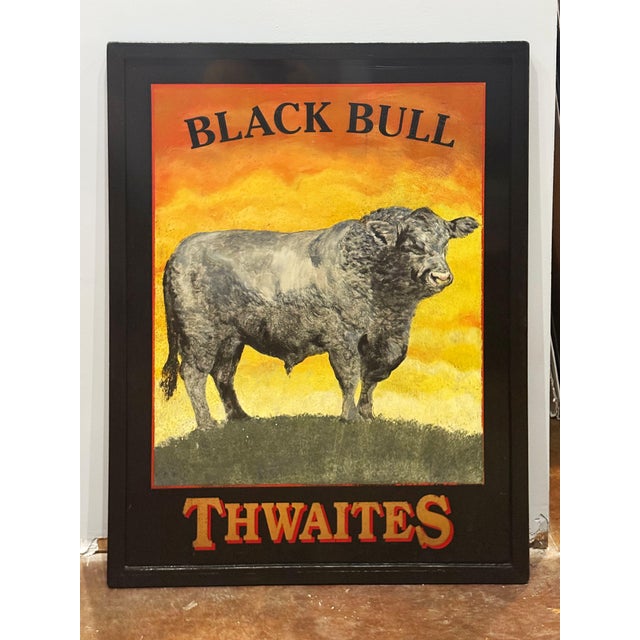 An authentic English pub sign (one-sided) featuring a painting of a large English black bull standing on a grassy hill,...