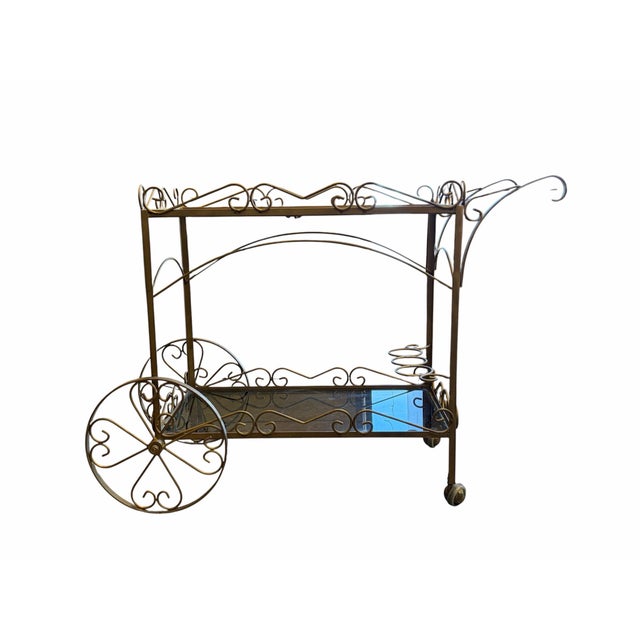 Add a touch of vintage glamour to your home with this stunning Mid-Century Hollywood Regency bar cart. Featuring an...