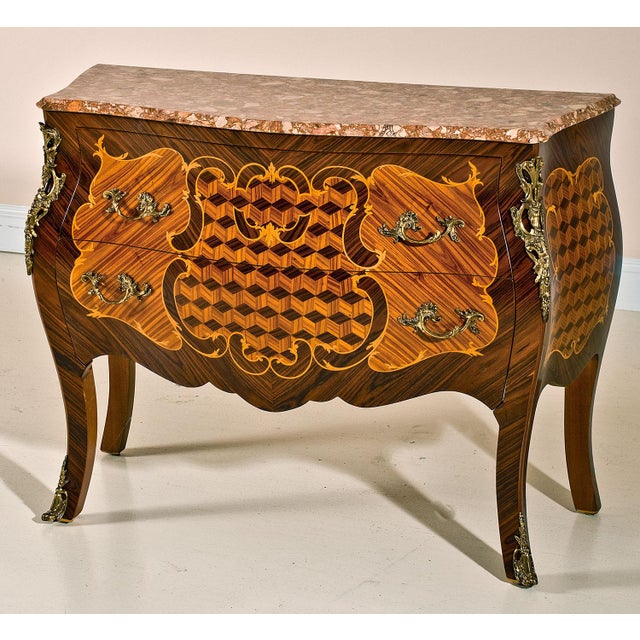 Handcrafted in Italy, this elegant bombe chest features satinwood veneers arranged in rich marquetry patterns across the...