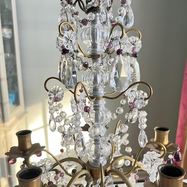 This is a beautiful French brass and crystal five-arm girandole candelabra with crystal swags and droplets adorning the...