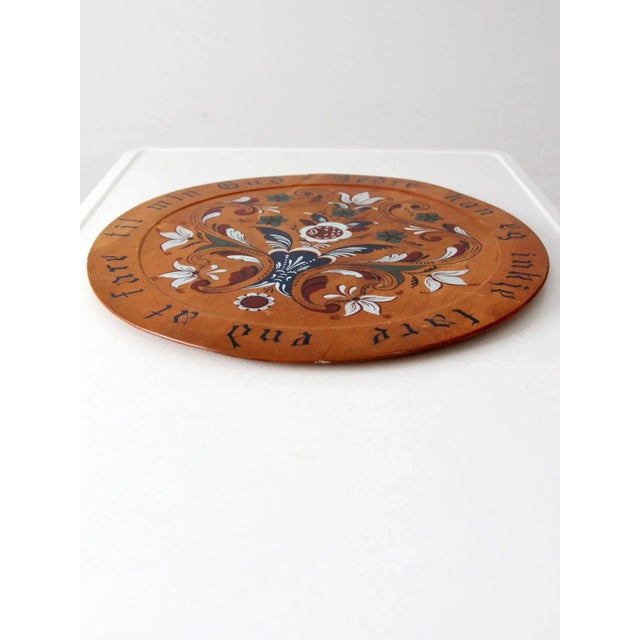 A vintage hand-painted Norwegian wood plate dated 1951. The large round plate features a beautifully detailed floral...