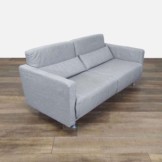 Sofa features metal legs and folds out into a full size sleeper sofa. Brand: Bo Concept. Model: Melo. No makers label...