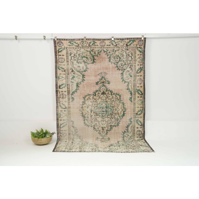 This vintage hand-knotted area rug is a semi-antique vintage area rug. The '70s Eastern Anatolian region's unique rug is...